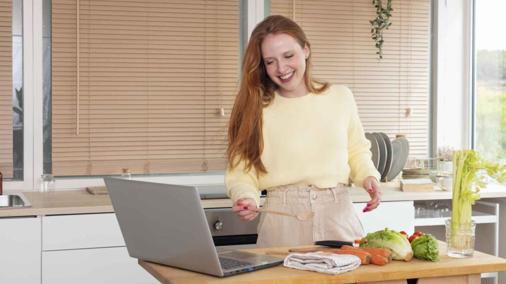girl-using-laptop-and-making-vegatable